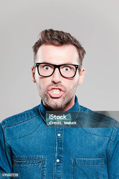 Portrait Of Surprised Man Wearing Jeans Shirt Bow Tie Glasses Stock Photo - Download Image Now