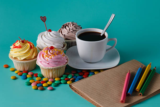 istock Cupcakes with colorful confetti and coffee cup 491658906