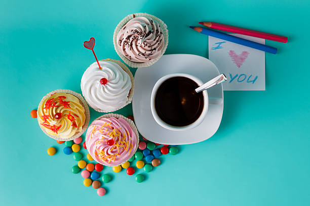 istock Cupcakes with colorful confetti and coffee cup 491658916