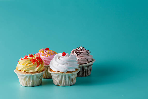 istock colorful pink cupcake on aquamarine background 491659186
