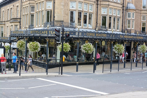 Harrogate, England - August, 23 2015: The famous Bettys Cafe and Tea Rooms in Harrogate, people can be seen walking outside the cafe