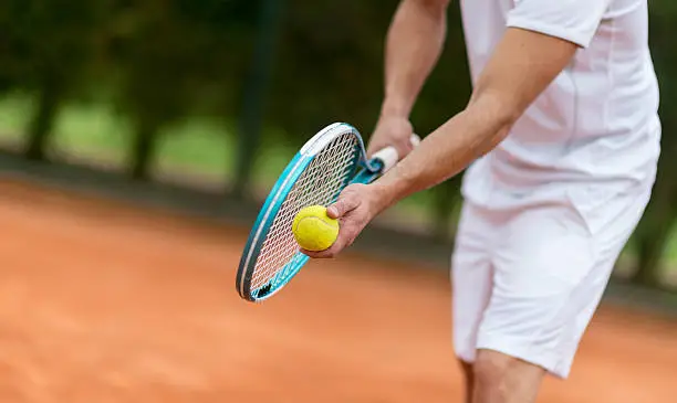 Close up on racket and ball during a tennis service