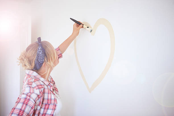 istock Young woman making a heart shape with paint brush 491665955