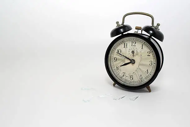 Photo of broken clock with isolated white background