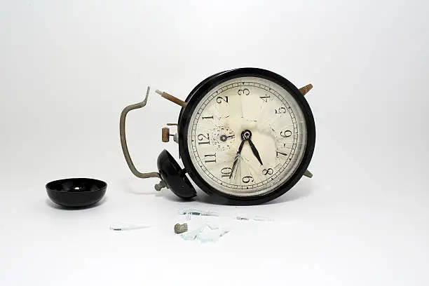 Photo of broken clock with isolated white background