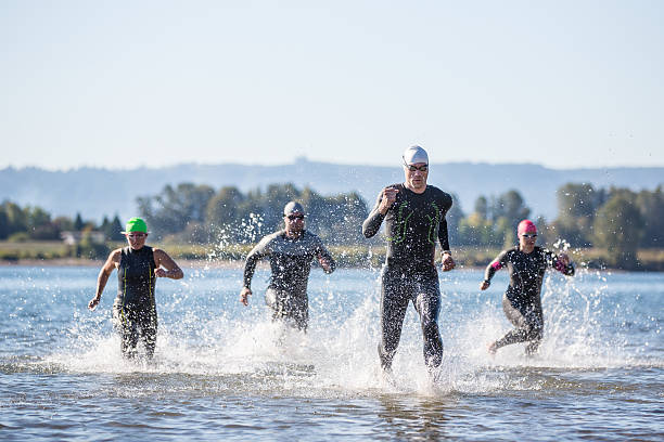 Triathletes training for a triathlon Triathletes training for a triathlon in the Pacific Northwest triathlon stock pictures, royalty-free photos & images