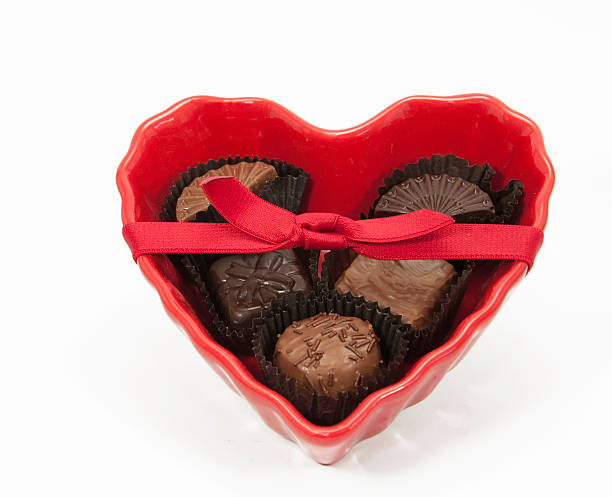 istock Chocolates in Heart Dish with Red Bow 491669279