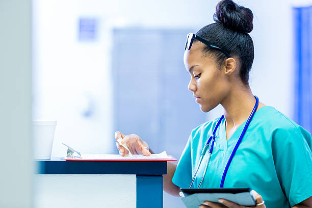 istock Nurse in hospital checking patient charts during rounds 491669480