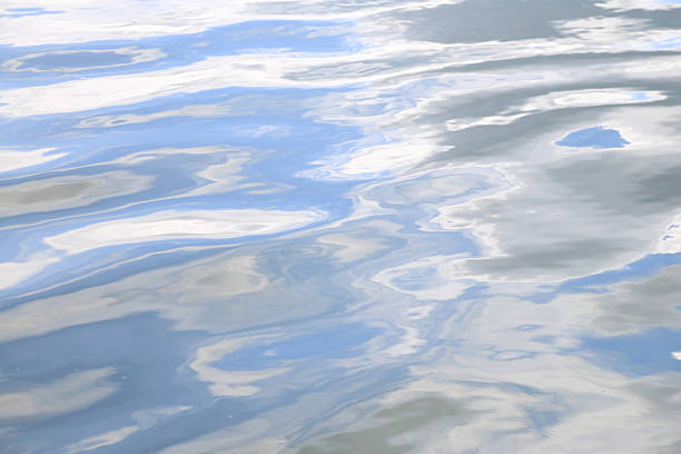 Water surface texture with soft ripples and sky reflection Water surface texture with soft ripples and sky reflection baptism stock pictures, royalty-free photos & images