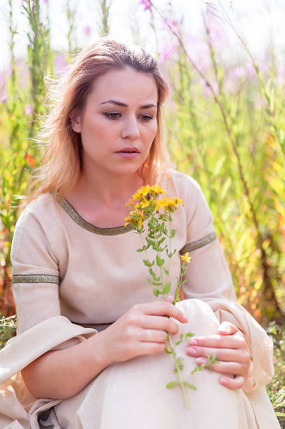 istock Beautiful sad girl sitting on meadow 491670123