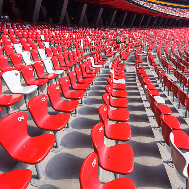 istock Red chairs bleachers in large stadium 491670519
