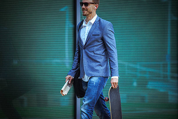 istock Young businessman carrying skateboard on the way to work 491671344