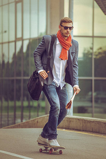 istock Young casual businessman comuting to work skateboarding. 491671438