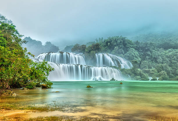 istock Ban Gioc Waterfall misty in the morning dew 491672612
