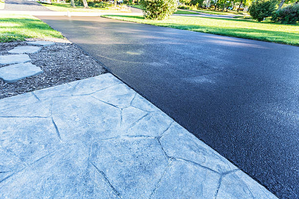 Residential Driveway New Blacktop Asphalt Resealing This suburban home asphalt driveway has just had a fresh blacktop resealing job finished. The black sealant is still wet; needing at least 24 hours to dry. sealant photos stock pictures, royalty-free photos & images