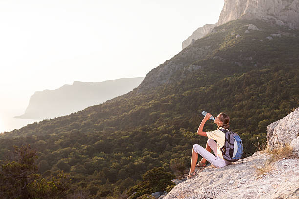 istock Woman drinks water on the mountain 491681176