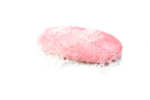 pink bar of soap with foam isolated on a white background