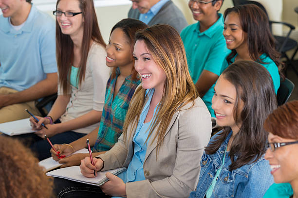 istock Diverse group of students in college lecture hall, taking notes 491681968