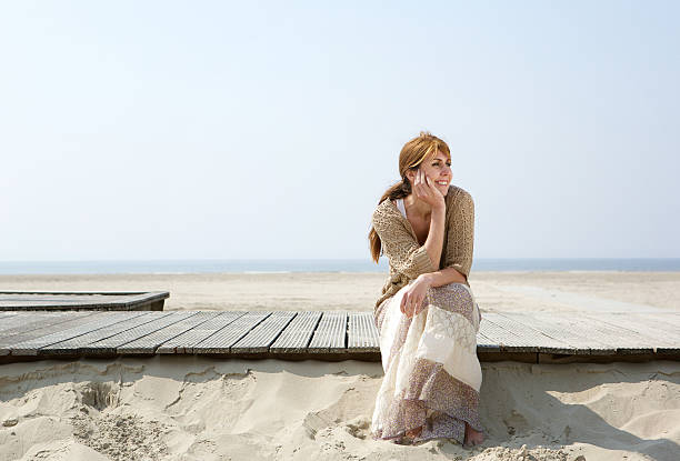 istock Woman sitting outdoors enjoying summer 491682569