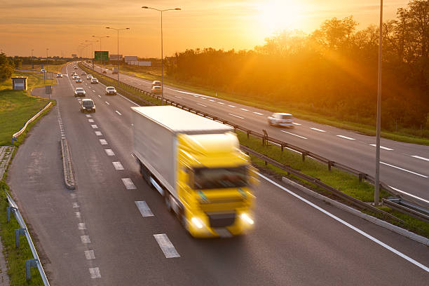 istock Yellow truck in the rush hour on highway 491682759