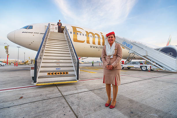 Emirates crew member near aircraft stock photo