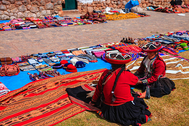 Peruvian women selling souvenirs at Inca ruins, Sacred Valley, Peru The Sacred Valley of the Incas or Urubamba Valley is a valley in the Andes  of Peru, close to the Inca capital of Cusco and below the ancient sacred city of Machu Picchu. The valley is generally understood to include everything between Pisac  and Ollantaytambo, parallel to the Urubamba River, or Vilcanota River or Wilcamayu, as this Sacred river is called when passing through the valley. It is fed by numerous rivers which descend through adjoining valleys and gorges, and contains numerous archaeological remains and villages. The valley was appreciated by the Incas due to its special geographical and climatic qualities. It was one of the empire's main points for the extraction of natural wealth, and the best place for maize production in Peru.http://bem.2be.pl/IS/peru_380.jpg chinchero district stock pictures, royalty-free photos & images