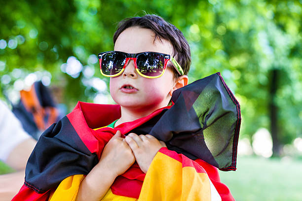 istock Little german supporter sings national anthem 491684245