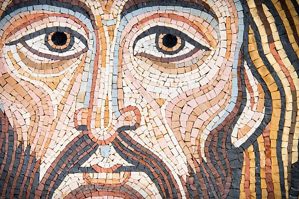 Mosaic representing Christ's Face, in byzantine style. Golden background. It is modern, made by a Sicilian artist, and looks like the Blessing Christ of the Monreale Cathedral or Cefalu' one. The background is made of golden leaf. This image is characteristic for its uniqueness.  