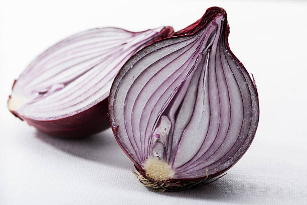Two halves of a red onion on white stock photo