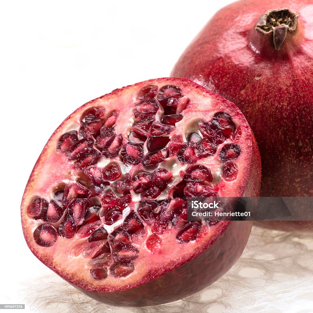 Close-up of a Pomegranate A pomegranate cut in half on a white background 2015 Stock Photo