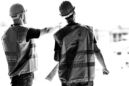 Civil engineers on a construction site. Black and white