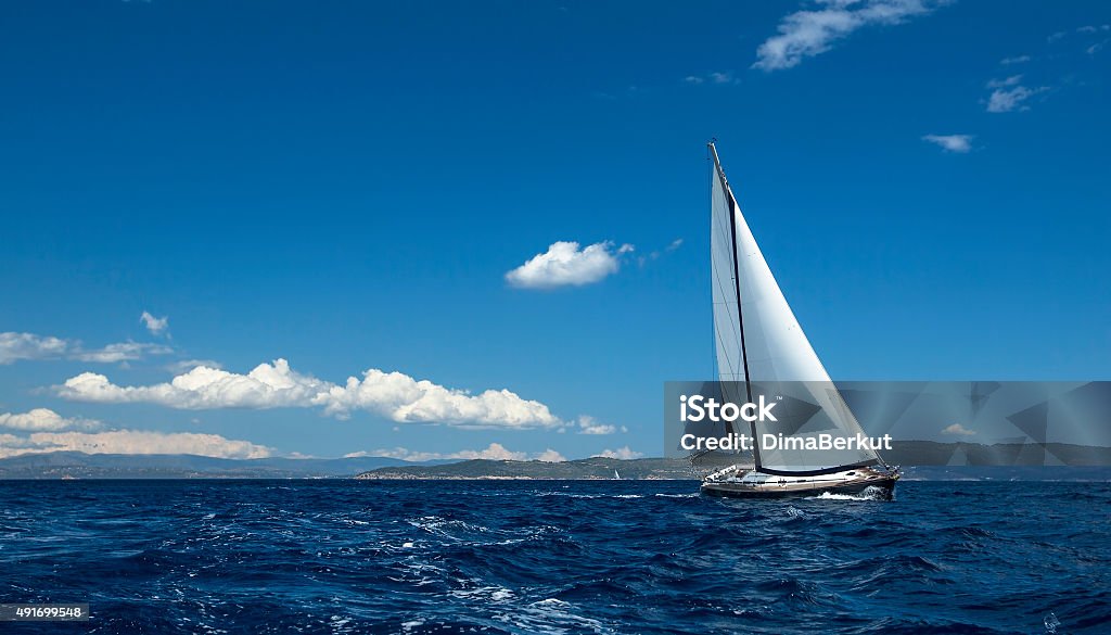 Ship yachts with white sails in the open Sea. Sailing Ship yachts with white sails in the open Sea. Sailing luxury boats. Sailboat Stock Photo