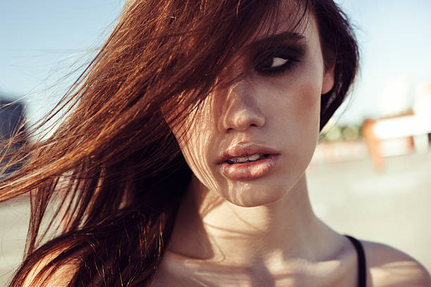 istock Young woman outdoors portrait. Soft sunny colors. 491700484