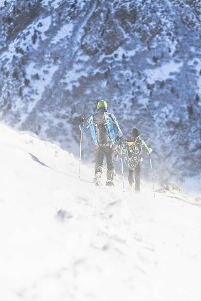 istock Two hikers descends on snow-covered trails in the high mountains 491700696