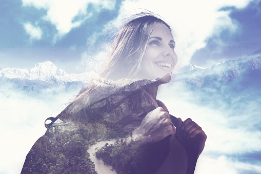 multi exposure effect of half transparent woman's portrait overlaying the mountain landscape (no color)