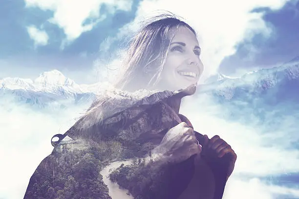 Photo of half transparent woman's portrait overlaying the mountain landscape