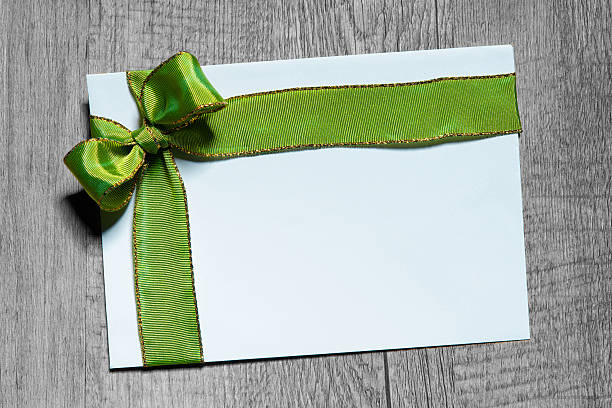 istock Holidays gift card with green bow 491701954