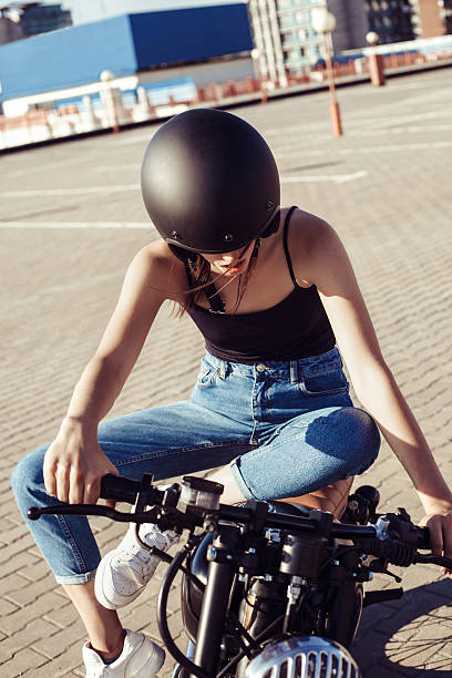 istock Biker girl sitting on vintage custom motorcycle 491702576