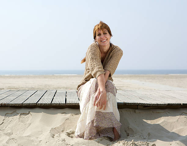istock Woman smiling at the beach in summer 491703911