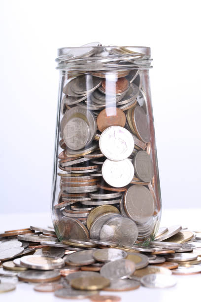istock filling up coins to glass for investment 491704155