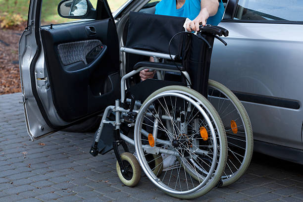 istock Man packing wheelchair into a car 491704517