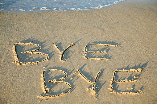 Written word LOVE on sand with copy space.