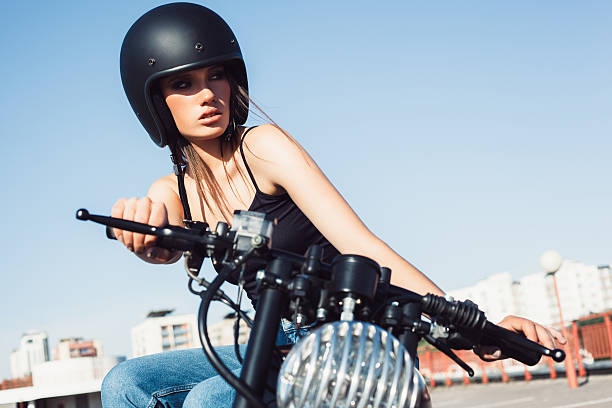 istock Biker girl sitting on vintage custom motorcycle 491707950