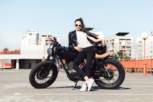 istock Biker girl sitting on vintage custom motorcycle 491708468