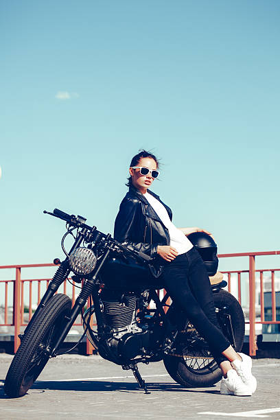 istock Biker girl sitting on vintage custom motorcycle 491708526