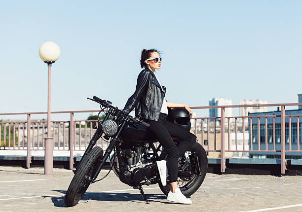istock Biker girl sitting on vintage custom motorcycle 491708588