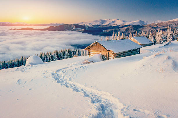 chalets in die berge bei sonnenuntergang - drifted stock-fotos und bilder