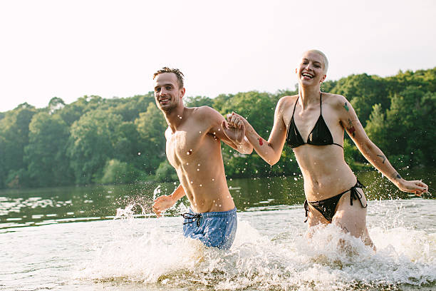 istock Good friends running into the lake 491709978