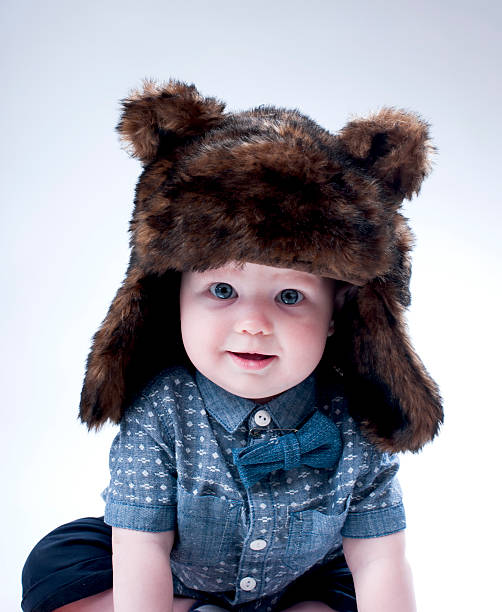 istock Funny baby boy  in a  brown fur hat . 491712268