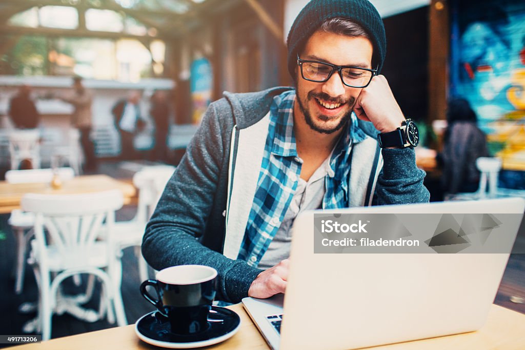 Coffee break Man having a break in a coffee with a laptop. Hipster Culture Stock Photo
